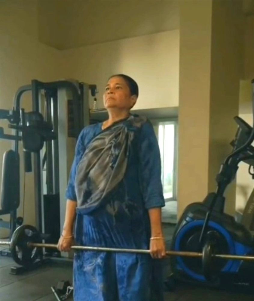 A Take Charge client deadlifting a barbell at the gym